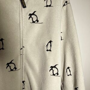 Womens white fleece jacket with little penguins on it.